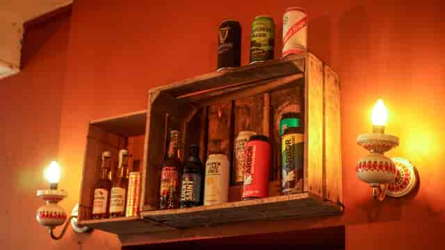Cloak Cafe/Bar beverage display on rustic shelf, perfect for networking events.