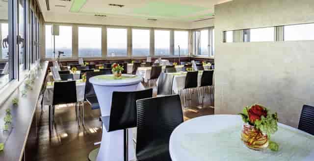 Modern event space at UP COLOGNE with elegant tables for corporate events and receptions.