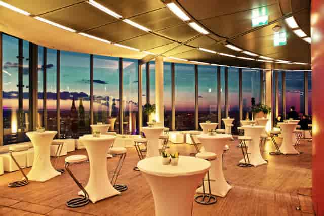 Sophisticated event space in Koelnsky with skyline view, perfect for networking and receptions.
