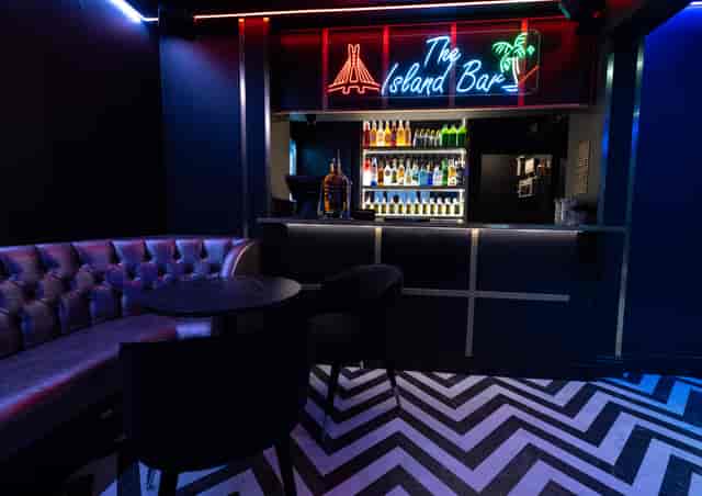 Main Lounge at Enish Restaurant, stylish bar with neon decor for networking events.