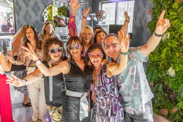 Vibrant attendees at Event Bar, Snoozebox Olympic Park, celebrating a lively networking event.