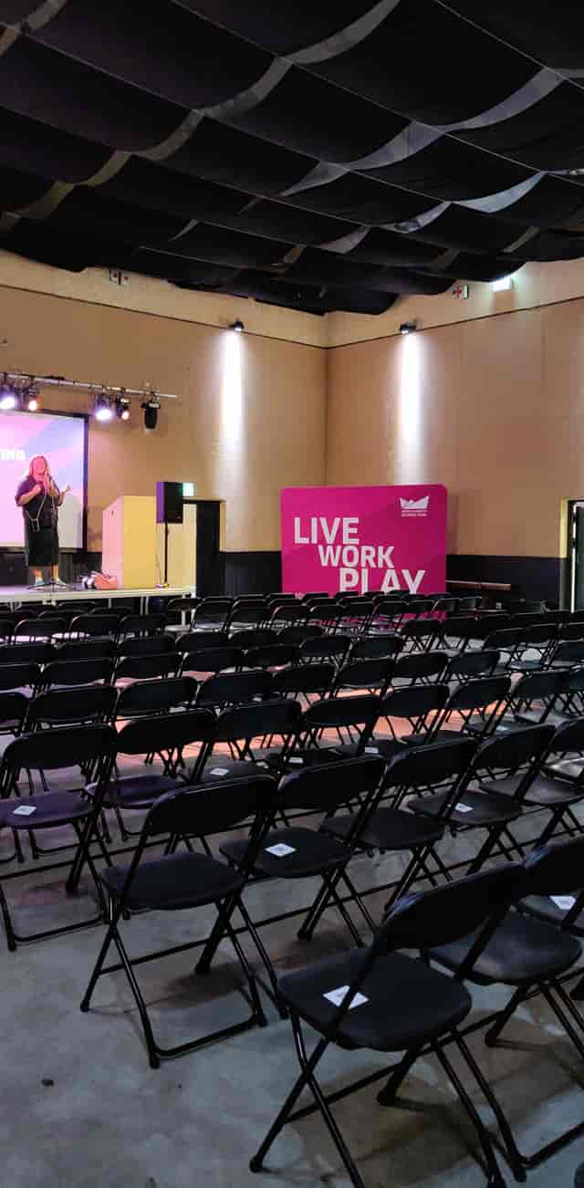 Event space in Hackney Bridge with stage, seating for networking and community engagement.