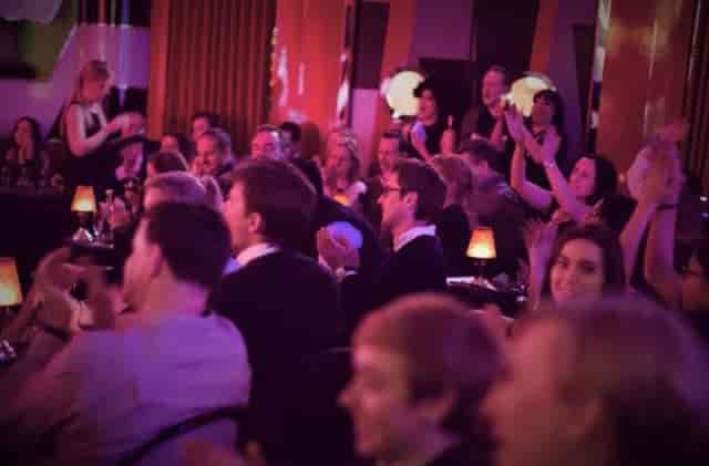 Lively audience applauding at The Crazy Coqs, Brasserie Zédel event.
