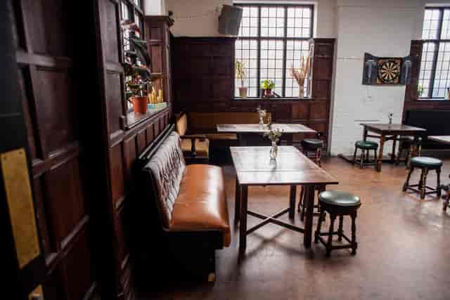 Cozy Games Room in Beehive with dartboard, perfect for gatherings and networking events.