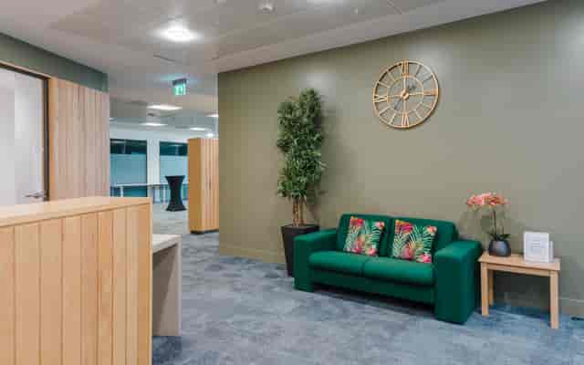 Modern lounge at Millennium Point with green sofa, ideal for networking events.