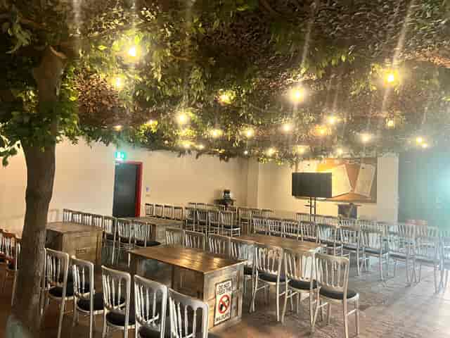 The Den at Bear Grylls Adventure: rustic event space with greenery, ideal for meetings and workshops.