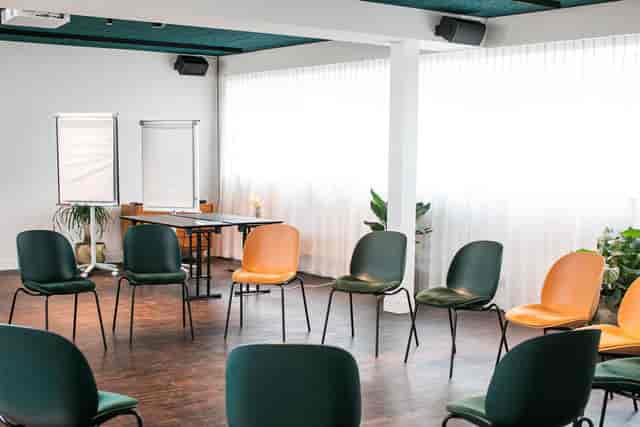 Conference room at Yalo Hotel with circular seating for workshops and team-building.