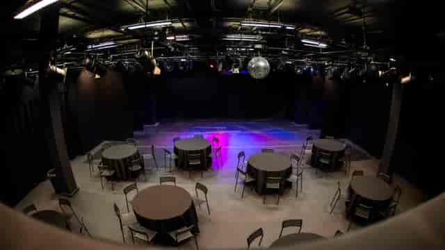 Dugdale Studio Theatre with round tables, ideal for networking and events.