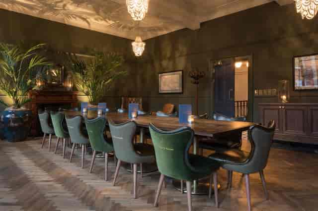 Sophisticated meeting space with wooden table for exclusive events at The Secret Bar.