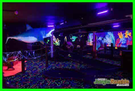 Vibrant neon-lit event space with marine theme for children's parties in Glasgow.