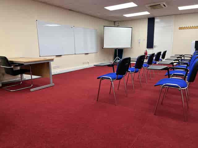 Training room in Whitechapel with blue chairs, ideal for meetings and workshops.