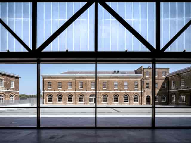 Modern event space with large glass windows in Woolwich Works, ideal for meetings and conferences.