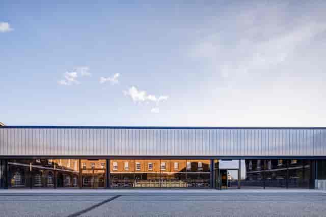 Modern event space in Woolwich Works with large glass windows for corporate and social gatherings.