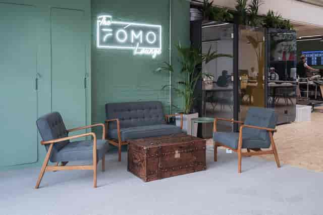 Stylish lounge in FOMO House, featuring vintage trunk coffee table for networking events.
