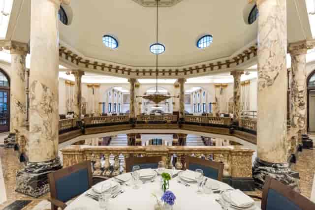 Elegant event space with grand columns at Royal Tropical Institute for upscale gatherings.