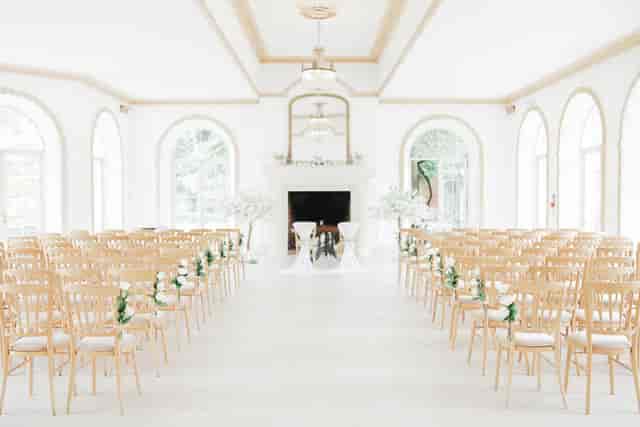 Elegant wedding ceremony setup in Vine Room, Northbrook Park with floral accents.