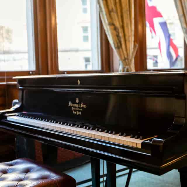 David Lloyd George Room with grand piano, ideal for live music events and receptions.