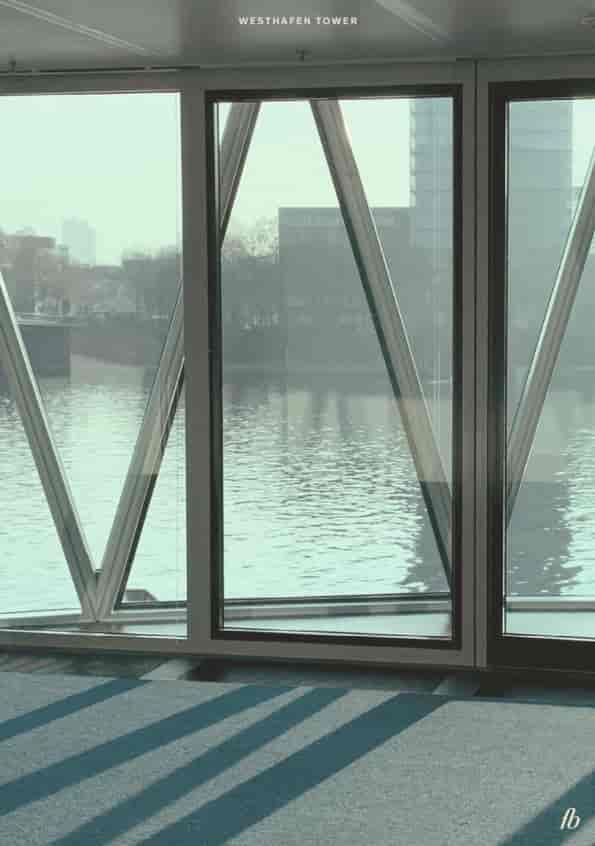 Westhafen Tower in Frankfurt: modern venue with glass windows for events and networking.