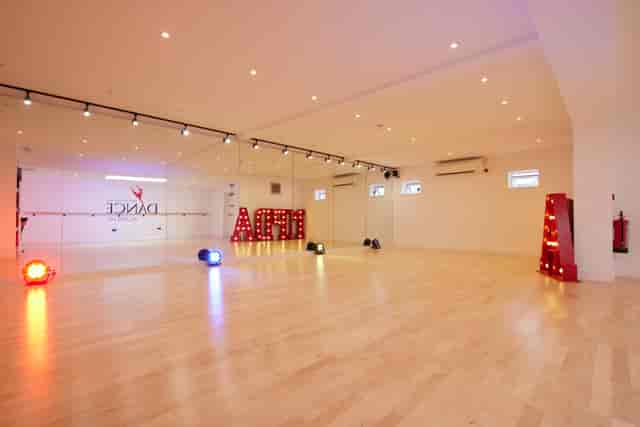 Versatile dance studio with polished wooden floors, ideal for workshops and events.
