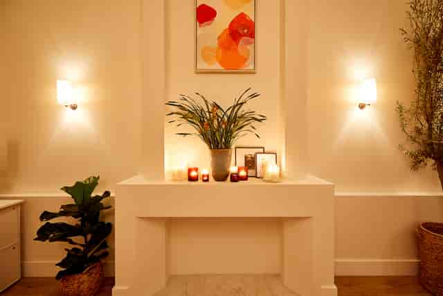 Serene event space with stylish mantel, ideal for intimate gatherings and wellness events.