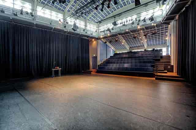 Theatre in Podium Mozaiek with spacious stage and tiered seating for events and performances.