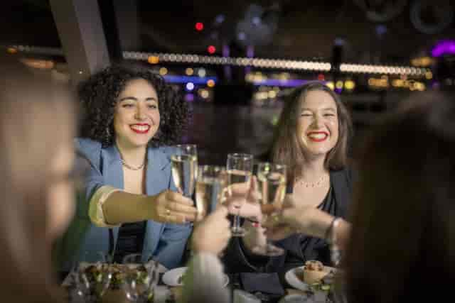 "Millennium of City celebration with attendees toasting at an upscale networking gala."