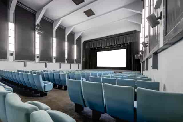 Ciné Lumière auditorium with blue seating, ideal for film screenings and events.