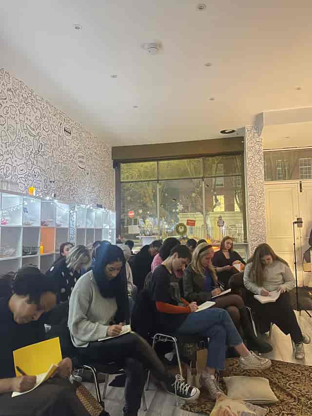 Gallery Show Room workshop with attendees note-taking in a warm, inviting space.