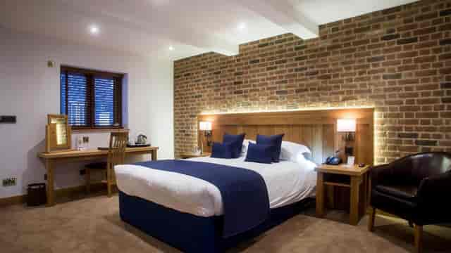 Meadow Barn at Tewinbury Hotel: modern room with exposed brick, perfect for events and business.