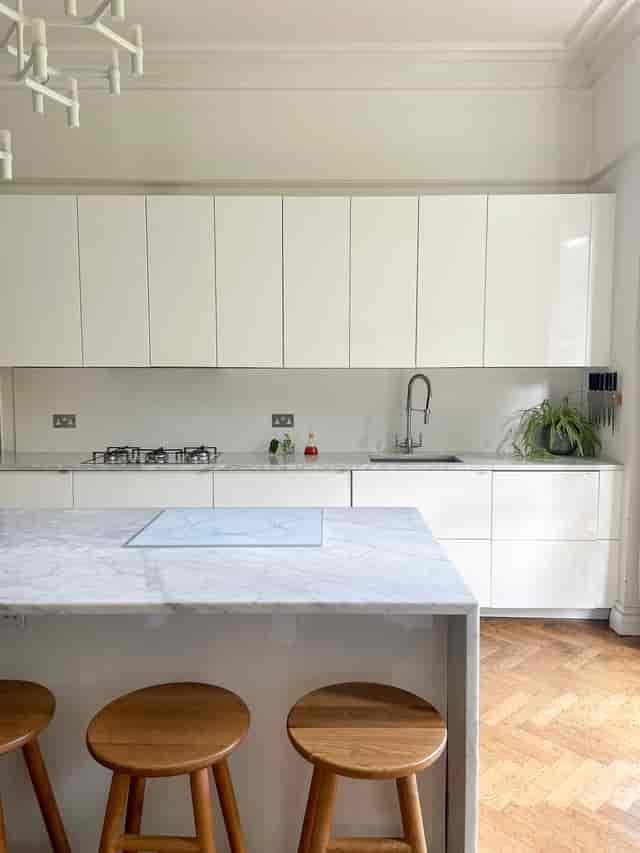 Modern kitchen studio with marble island for culinary events and workshops.