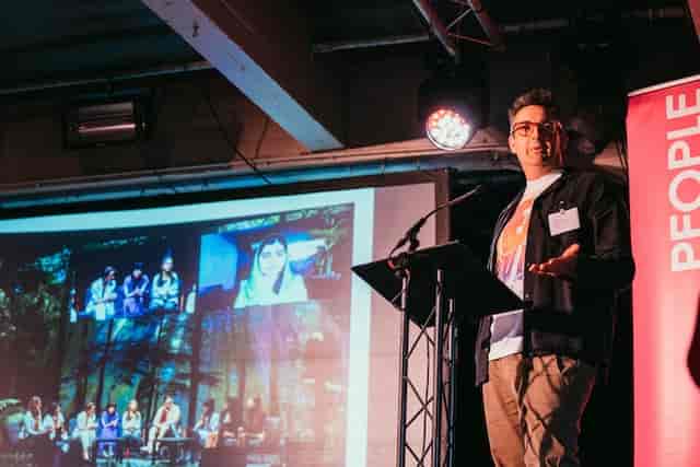 Keynote presentation at SWG3 Warehouse, featuring live stage lighting for corporate events.