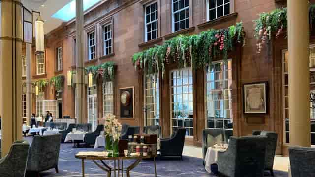 Peacock Alley at Waldorf Astoria Edinburgh, elegant event space with lush greenery.