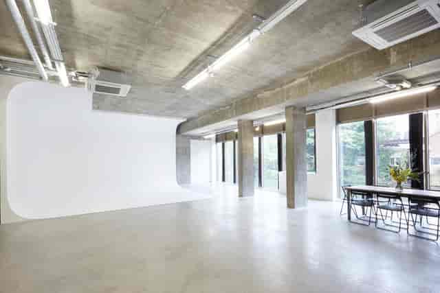 Modern industrial event space with natural light for corporate meetings and workshops.