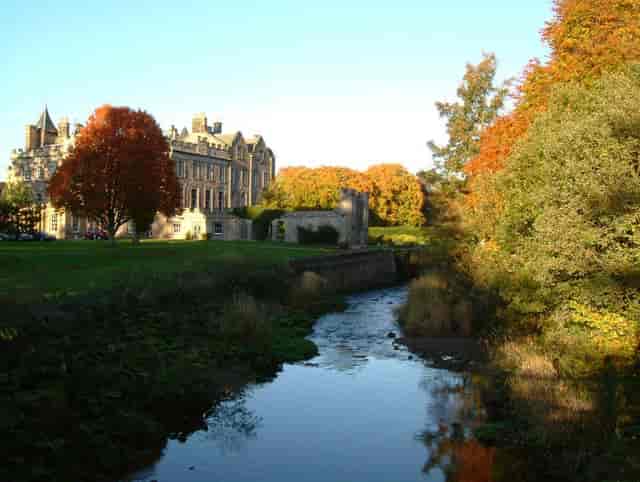 Stunning Newbattle Abbey venue with autumn foliage, ideal for outdoor weddings and retreats.