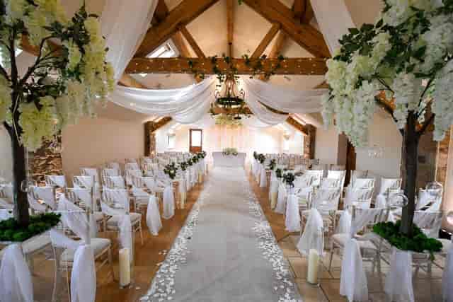 Elegant wedding ceremony space with floral accents and soft lighting at Beeston Manor.