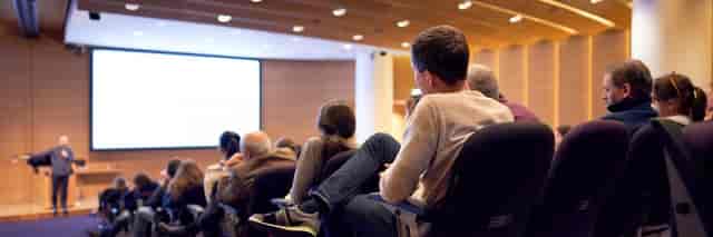 Engaged audience in modern conference at The Francis Crick Institute, highlighting effective seating.
