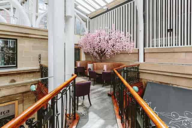 Elegant restaurant with cherry blossom tree, perfect for meetings and social events.
