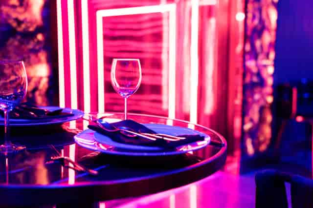 Stylish table setting with elegant dinnerware in modern DAARK venue for upscale events.