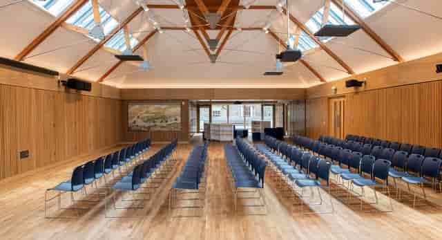 Breakout room with blue chairs, ideal for conferences and workshops.
