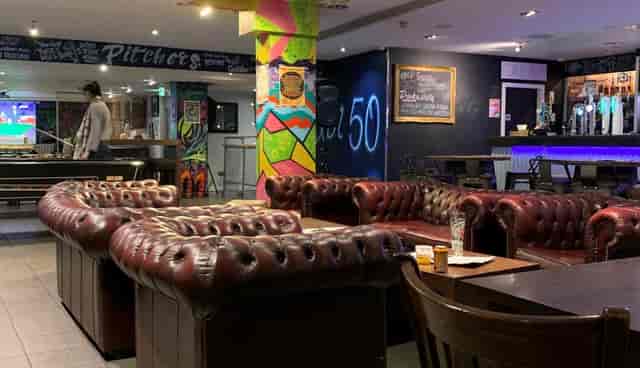 Bar 50 beer garden with Chesterfield sofas for corporate networking and team-building events.