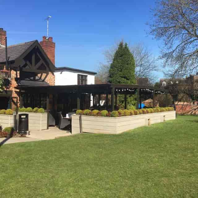 Charming Beer Garden venue with lush greenery, perfect for outdoor events and gatherings.