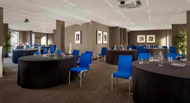 Modern meeting space in Marlowe with round tables, ideal for workshops and corporate events.
