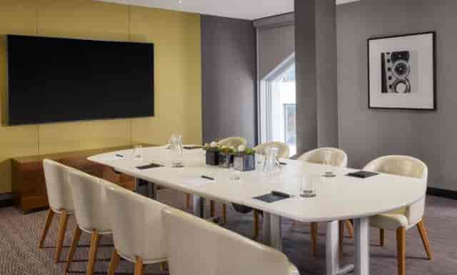 Modern meeting room in Marlowe with sleek table, ideal for collaborative events.