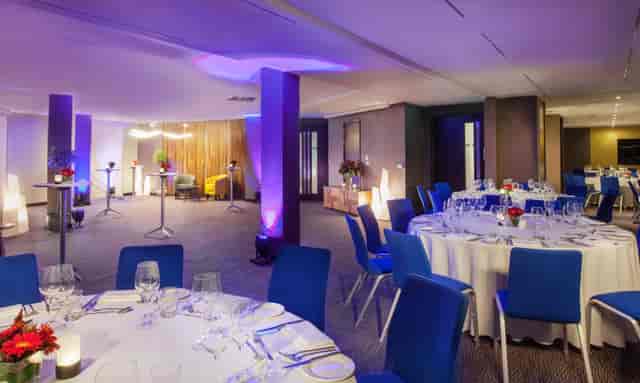 Sophisticated event space with round tables, ideal for corporate meetings and social gatherings.