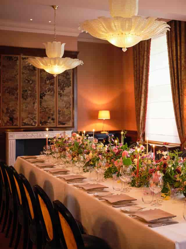 Elegant dining table with floral arrangements at The NoMad London for upscale events.