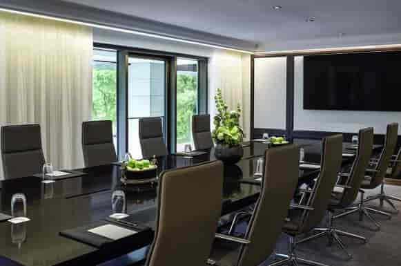 Modern conference room at Sofitel Frankfurt Opera with sleek black table and natural light.