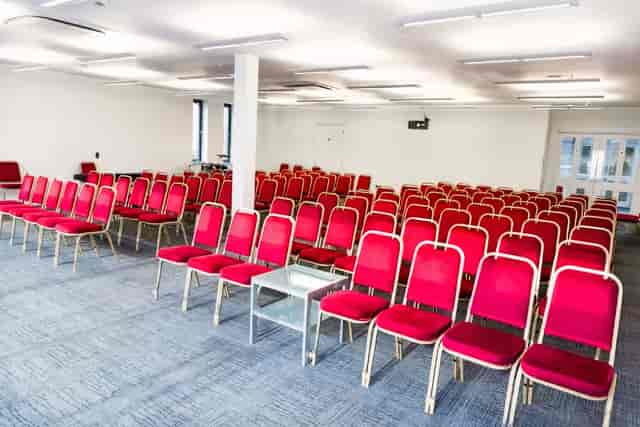 Emerald Suite in The Rock Tower: red chairs for conferences and seminars.