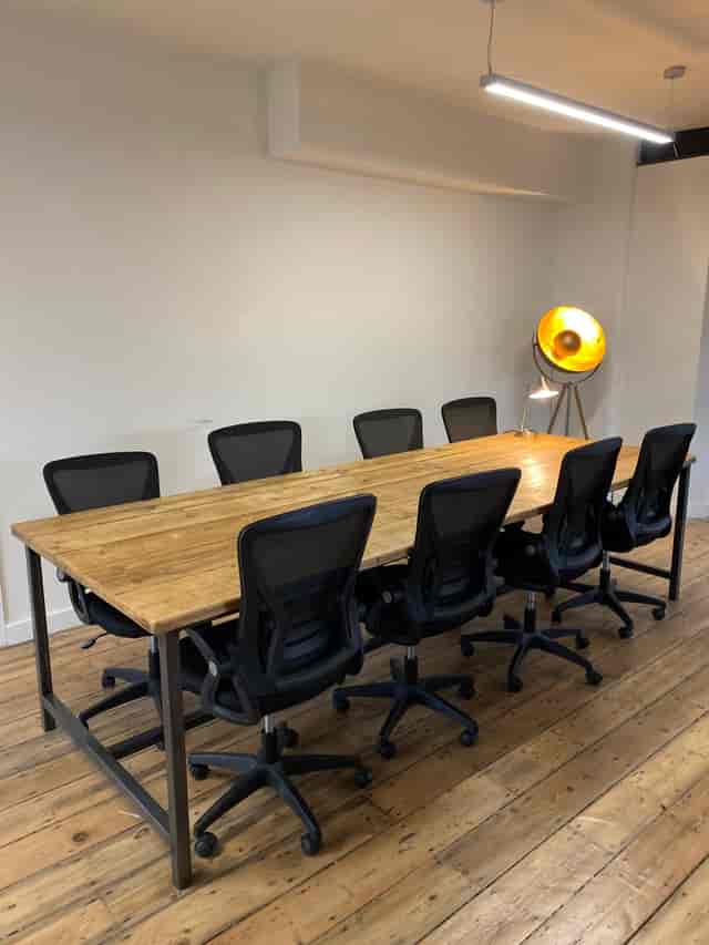 Modern conference room with wooden table and ergonomic chairs for collaborative events.