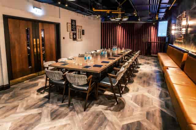 Exclusive meeting room at Puttshack Watford for corporate events, featuring elegant table setup.