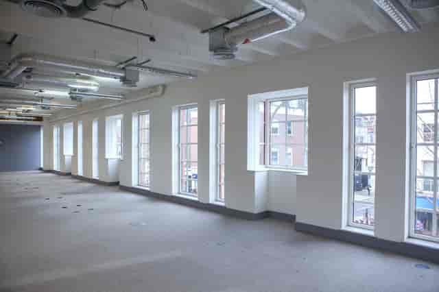 Spacious event space with large windows for meetings and workshops in Chelsea.